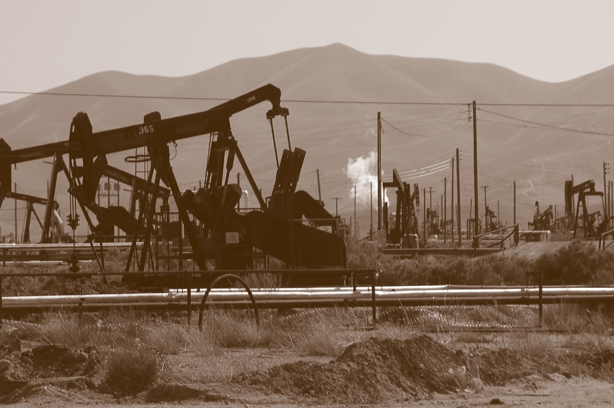A sepia photo of oil pumps in California